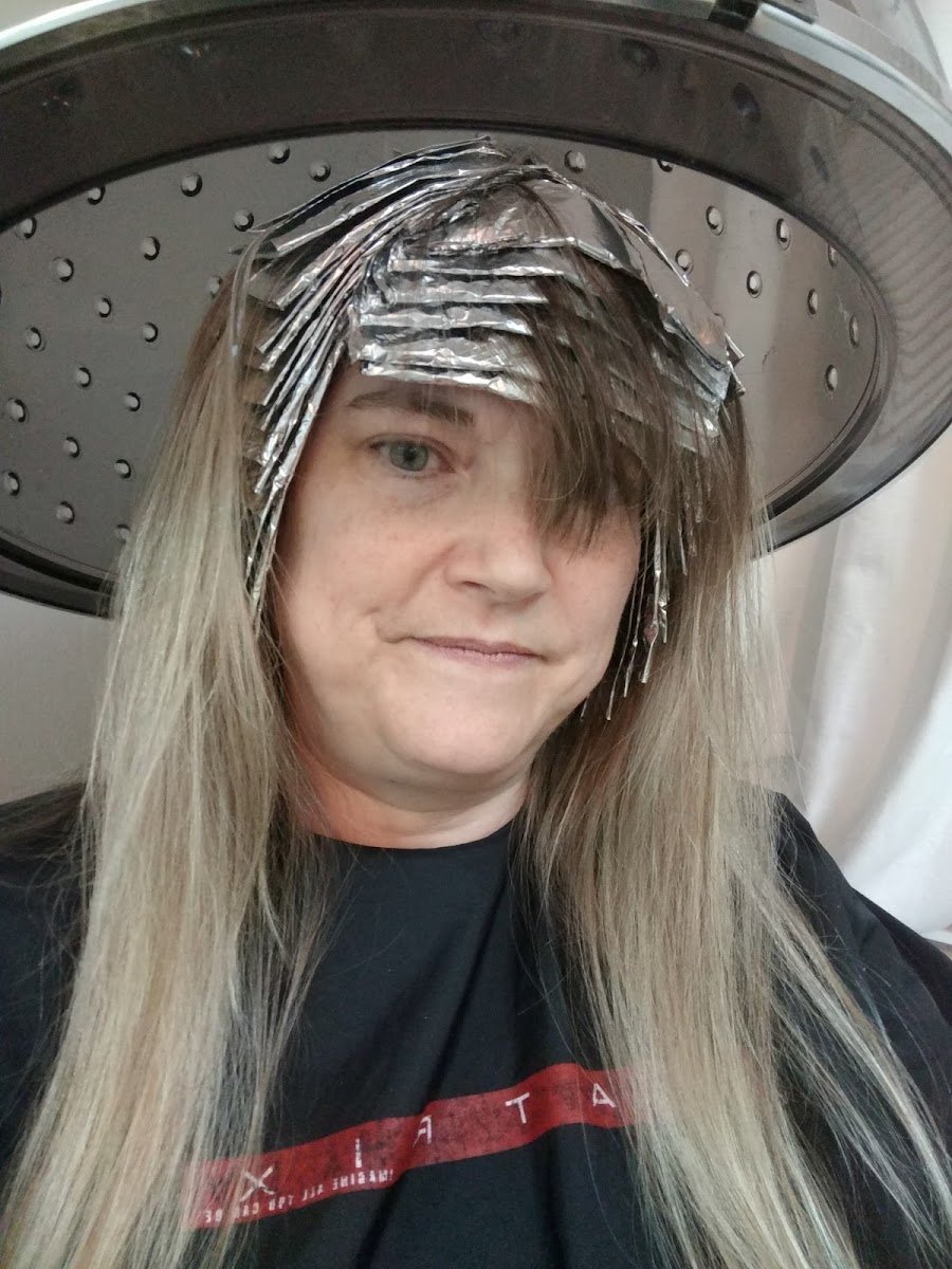 Client receiving professional hair coloring with foils at Glow A Salon by Meredith Capps in Jackson, Tennessee