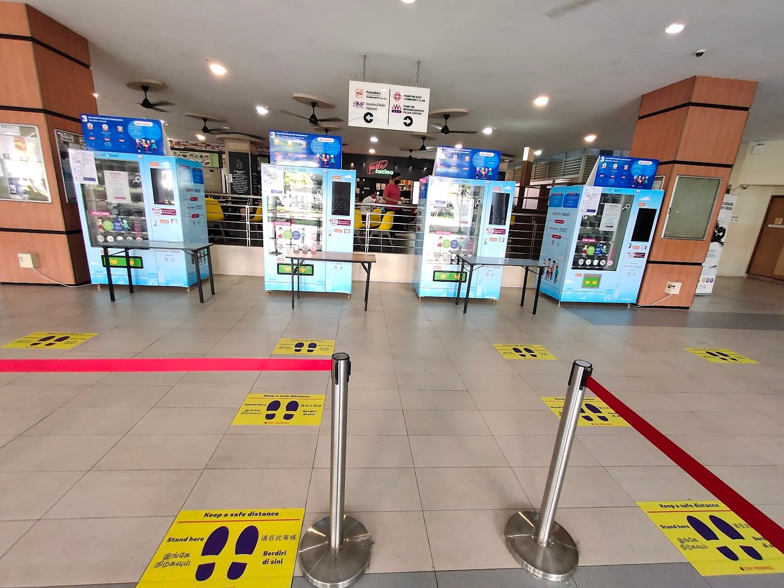 Indoor lobby of East Community Building with wayfinding to Pasir Ris East Community Club, polyclinic, AMP, and the neighbourhood police centre