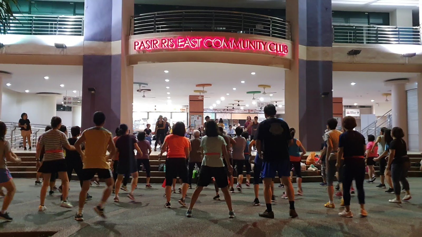 Group fitness session at night in the plaza of Pasir Ris East Community Club