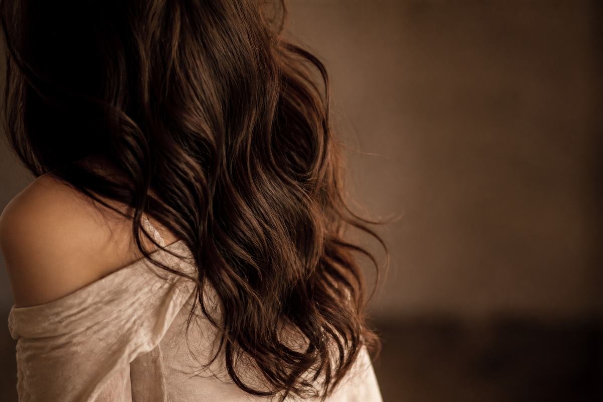 Editorial photograph of soft digital perm waves in dark hair