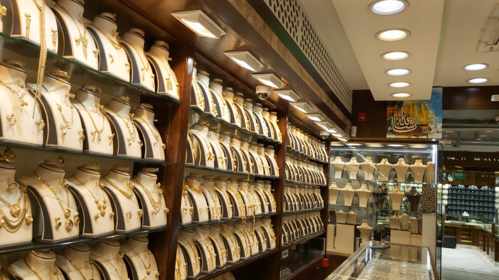 Gold necklace sets displayed on white busts inside a jewellery shop at Taiba Market in Riyadh