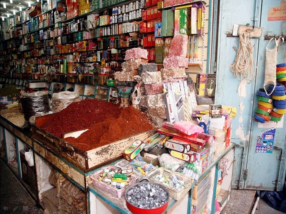 Traditional spice, incense and herbal products on a counter inside Taiba Market