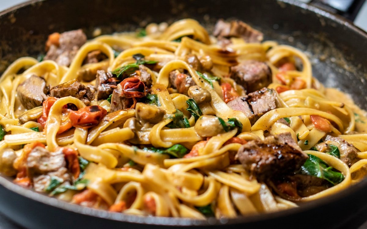 Handmade pasta with rich sauce representing The Food Lab beef ragu
